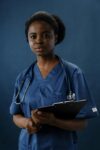 African American woman wearing blue scrubs with statoscope