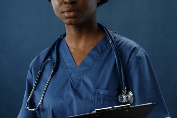 African American woman wearing blue scrubs with statoscope