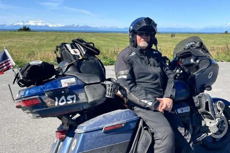 man sitting on a bike wearing a black helmet