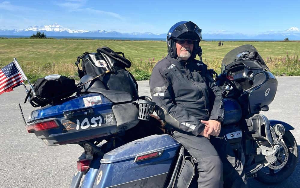 man sitting on a bike wearing a black helmet